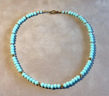 Load image into Gallery viewer, Turquoise beaded necklace with gold accents on a beige background