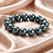 Load image into Gallery viewer, Pearl bracelet on a soft pink fabric background