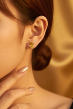 Load image into Gallery viewer, Close-up of a woman wearing a citrine gemstone stud earring with a blurred background