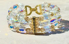 Load image into Gallery viewer, Bracelet with clear and gold beads on a light background