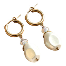Load image into Gallery viewer, Gold hoop earrings with white teardrop-shaped charms on a white background