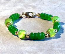 Load image into Gallery viewer, Green beaded bracelet with gold accents on a light background