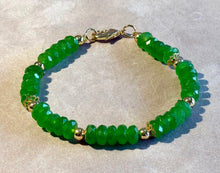 Load image into Gallery viewer, Green beaded bracelet with gold accents on a light gray background