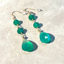 Load image into Gallery viewer, Green teardrop earrings on a white sandy background