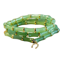Load image into Gallery viewer, A green jade-like beaded bracelet styled like bamboo stalks with gold spacer rings and a small gold horseshoe charm, shown on a plain white background.