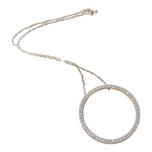 Load image into Gallery viewer, A silver-toned open circle pendant necklace paved with clear stones, suspended from a delicate matching chain on a plain white background.
