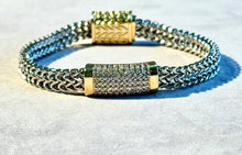 Load image into Gallery viewer, Bracelet with gold and silver accents on a light background