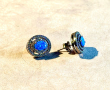 Load image into Gallery viewer, Pair of blue gemstone earrings on a beige surface