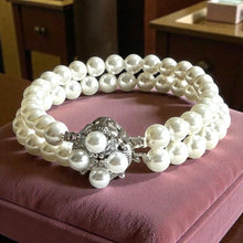 Load image into Gallery viewer, Pearl bracelet with a silver clasp on a pink cushion