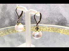 Load and play video in Gallery viewer, Video of white Freshwater pearl earrings in gold