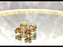 Load and play video in Gallery viewer, Video of blue topaz earrings in gold
