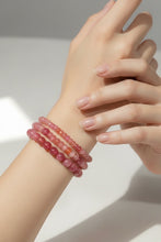 Load image into Gallery viewer, Close-up of a wrist wearing three pink beaded bracelets on a neutral background
