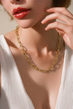 Load image into Gallery viewer, Gold chain necklace worn by a model with a neutral background
