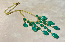 Load image into Gallery viewer, Green necklace with teardrop-shaped beads on a beige background
