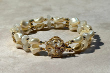 Load image into Gallery viewer, Pearl bracelet with gold accents on a light gray background
