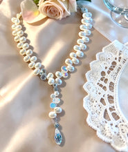 Load image into Gallery viewer, Pearl necklace with crystal pendant on a lace doily

