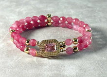 Load image into Gallery viewer, Pink beaded bracelet with gold accents on a light gray background
