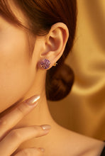 Load image into Gallery viewer, Close-up of a person wearing a purple gemstone earring with a blurred background
