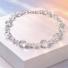Load image into Gallery viewer, Crystal necklace on a white surface with a soft focus background
