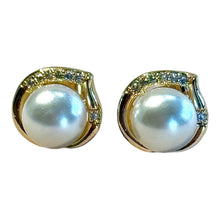 Load image into Gallery viewer, Pair of pearl earrings with gold and gemstone accents on a white background
