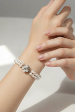 Load image into Gallery viewer, Pearl bracelet on a wrist with a neutral background
