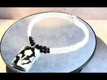 Load and play video in Gallery viewer, White and black gemstone necklace with flower pendant
