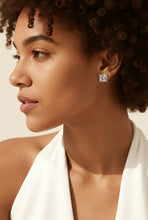 Load image into Gallery viewer, Close-up of a woman wearing a gold earring with a white background
